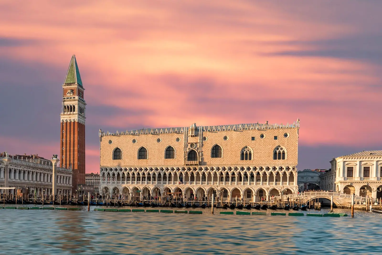 Doge’s Palace and St Mark’s Campanile at sunset, viewed across the water.